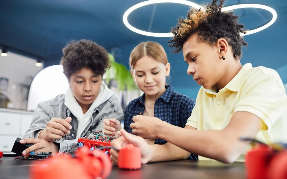 Teenage students working together on a robotics project; illustrative stock photograph, not Formativelabz people or facilities