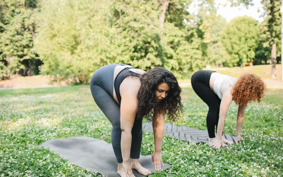 Two adults practising movement and wellness outdoors; illustrative stock photograph, not Formativelabz people or facilities